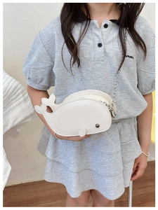 Detail view of the white dolphin-shaped crossbody bag with a silver metal chain for kids