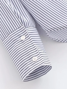 Detailed macro view of striped poplin shirt cuffs with a two-button adjustable design