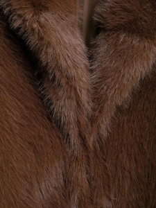 Macro detail of high-quality brown faux fur collar and wool blend texture on the coat