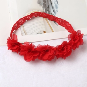Detailed view of bright red chiffon flowers and lace elastic headband for baby girls