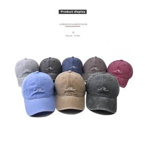 Detailed grid of vintage washed cotton baseball caps with wave embroidery in eight colors