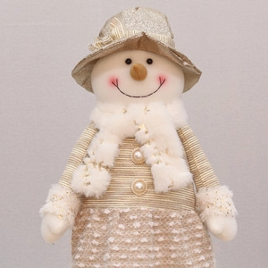 Close-up of champagne gold sequined snowman doll with faux fur and pearl buttons
