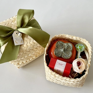 Handcrafted bamboo gift box set with green ribbon, ceramic persimmon jar, and tea