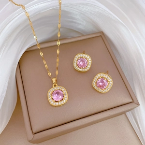 Luxurious gold square pink zircon necklace and earrings set on a jewelry box