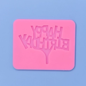 Pink silicone Happy Birthday mold for baking and fondant on a blue background