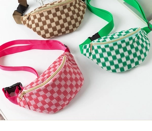 Detailed view of checkered knit fanny packs in pink, green, and brown with metal zippers