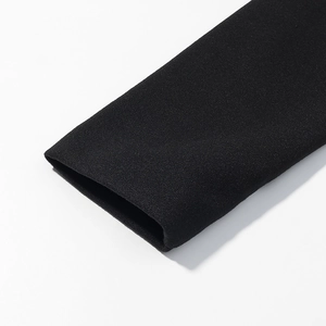 Detailed macro view of the black long sleeve cuff texture on this woolen commuter coat