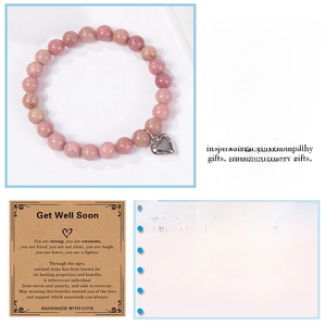 Detail of pink natural stone beaded bracelet with heart charm and get well soon gift card