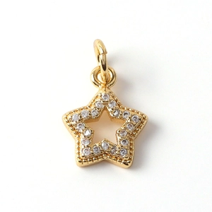 Close-up of a gold-plated star pendant with micro-pave zircons and hollow design