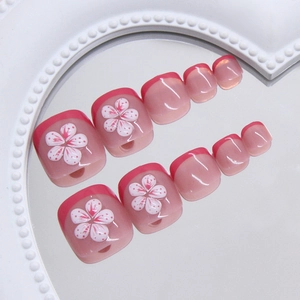 Press-on toenails featuring cherry blossom floral designs and pink French tips