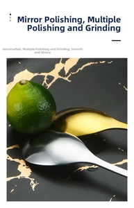 Detail of mirror-polished gold and silver leaf spoons on a black marble tray
