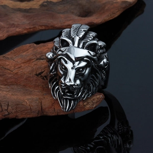 Vintage silver lion head ring for men with punk rock style on textured wood background
