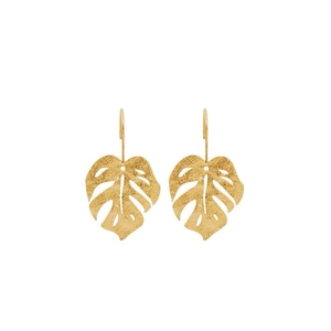 Detail of golden monstera leaf earrings with a matte metallic texture and hook design