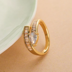 Irregular gold-plated ring with pear-shaped zircon and baguette side stones on ceramic rim