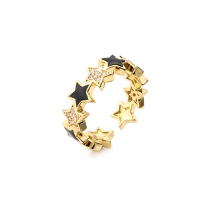 Macro detail of gold-plated star ring with black enamel and micro-set cubic zirconia