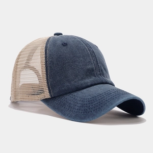 Close-up of trucker hat showing blue denim texture and breathable beige mesh back