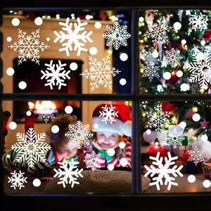 Detailed view of white snowflake static window stickers on glass for Christmas home decor