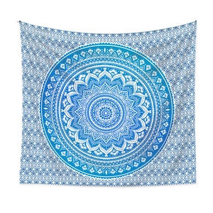 Close-up of mandala wall tapestry with intricate blue and white bohemian geometric patterns