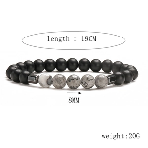 Detail showing 8mm natural lava stone beads and stainless steel cross on 19cm bracelet