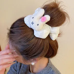 Cute plush bunny hair scrunchie with pink polka dot fabric for high ponytail hairstyles
