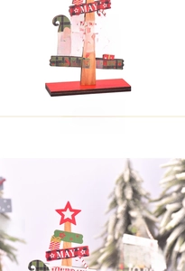 Detail of wooden Christmas desktop ornament featuring a red base and hand-painted festive signs