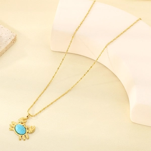 Close-up of 18K gold plated crab pendant with blue natural stone on beaded chain