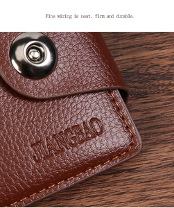 Detail of brown litchi pattern leather wallet featuring bronze buckle and fine stitching