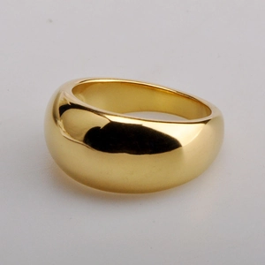 Macro detail of a wide polished gold dome ring with a smooth mirror finish