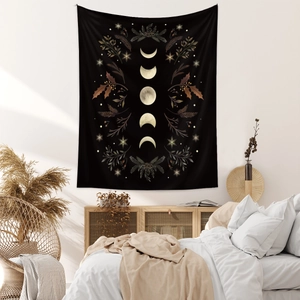 Detail of moon phase tapestry showing floral patterns above a cozy bed in a modern room