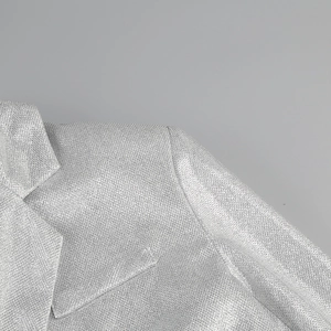 Close-up of silver sequin blazer featuring shimmering metallic fabric and lapel details