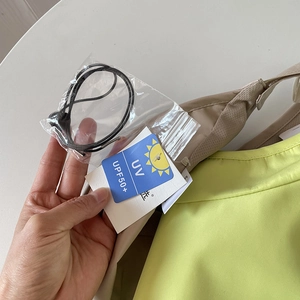 Detail view of the UPF 50+ UV protection hangtag and detachable windproof chin strap