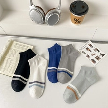 Set of five colorful low-cut ankle socks with stylish stripes on a white background