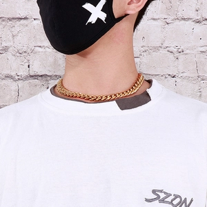 Macro shot of a 12mm gold Cuban chain necklace with CNC diamonds on a male model