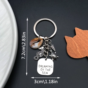 Macro view of sea horse keychain with shell and Dreaming of the Sea engraved charm