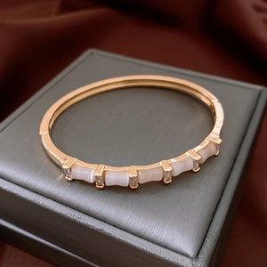 Vue détaillée du bracelet jonc doré style bambou avec pierres d'opale et zircons brillants