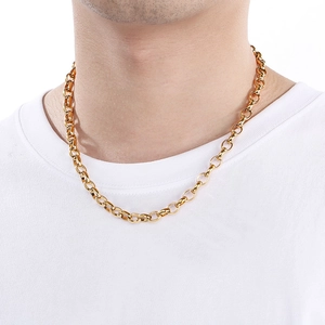 Close-up of a gold oval link egg chain necklace worn by a male model for fashion styling