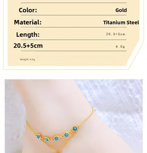Close-up of double-layer gold anklet with turquoise beads and tree of life pendant detail