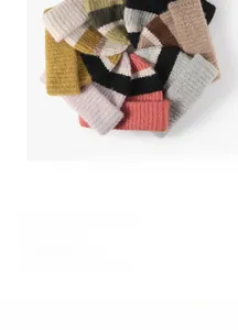 Detailed view of colorful striped knit beanies with premium ribbed texture and multi-color patterns