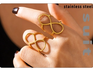 Detailed view of two 18K gold plated stainless steel rings in a unique figure-8 design