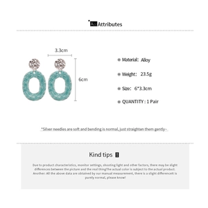 Detail view of light blue marble textured oval pendant earrings with dimensions and weight