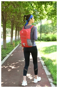 Outdoor red backpack with reflective strips and mesh side pockets for hiking