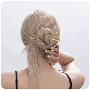 Golden heart-shaped stainless steel hair pin for women bun hairstyles on model