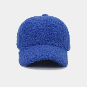 Detailed texture of thick bright blue fleece fabric on a warm winter baseball cap