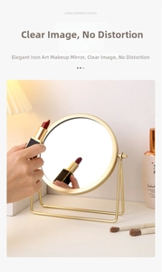 Detail of a gold iron desktop makeup mirror with a minimalist stand and clear reflection