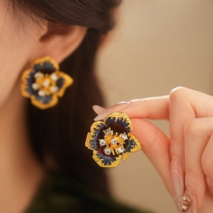 Vintage flower earrings with blue enamel and sparkling diamonds on a gold-plated base