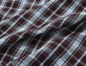 Detailed view of the woven plaid fabric with dark reddish-brown and blue checkered pattern