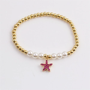 Bracelet de style océan plaqué or avec perles et pendentif étoile de mer en strass rose
