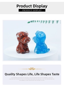 Detailed close-up of blue and brown crystal schnauzer resin figurines on a white base