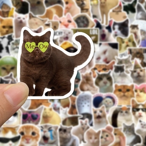 Close-up of hand holding various cute and funny cat meme stickers for decoration