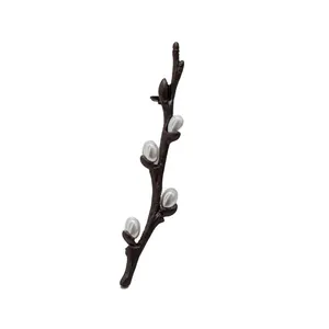 Elegant plum blossom branch brooch with brown finish and five waterdrop pearls on white background